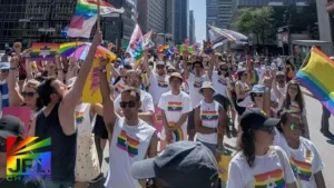 JRL CHARTS coverage – Jewish LGBTQ marchers at Montreal Pride waving rainbow flags and Stars of David after Zionist ban reversal – Photo by Julien Corona.