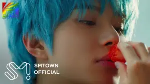 NCT’s Jungwoo poses in colorful teaser image for his solo debut single “SUGAR.”