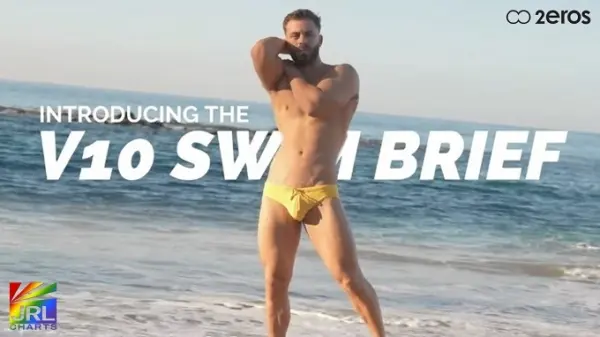 Male model wearing 2EROS V10 swim brief in yellow during UNCOVERED campaign commercial filmed on a beach for Spring Summer 2026 retail launch.