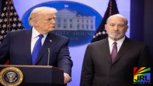 Donald Trump stands at podium beside Howard Lutnick in the White House during cabinet shake-up discussions in 2026
