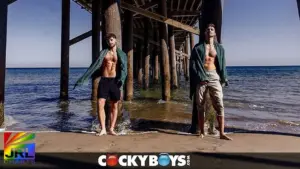 Kane Fox and Dex Devall stand beneath a California pier in CockyBoys’ cinematic summer feature “The Getaway.”