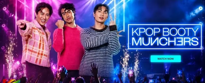 Three stylish K-pop inspired performers headline MEN.com’s “KPop Booty Munchers” in a cinematic neon concert setting with Hollywood-style stage lighting and cheering crowd.