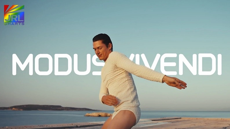 Male dancer wearing MODUS VIVENDI Ballet Line underwear performing mid-air ballet pose against sky background