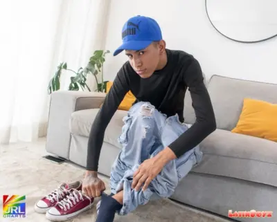 Diego of Venezuela poses in a modern living room during a casual lifestyle photo session for LatinBoyz.